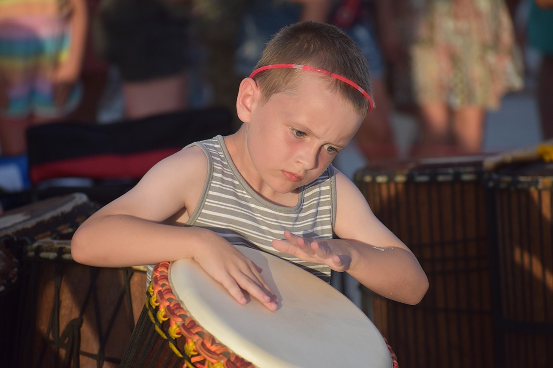 Will Westendorf, 8, of Cincinnati, who loves music, tries out a drum.