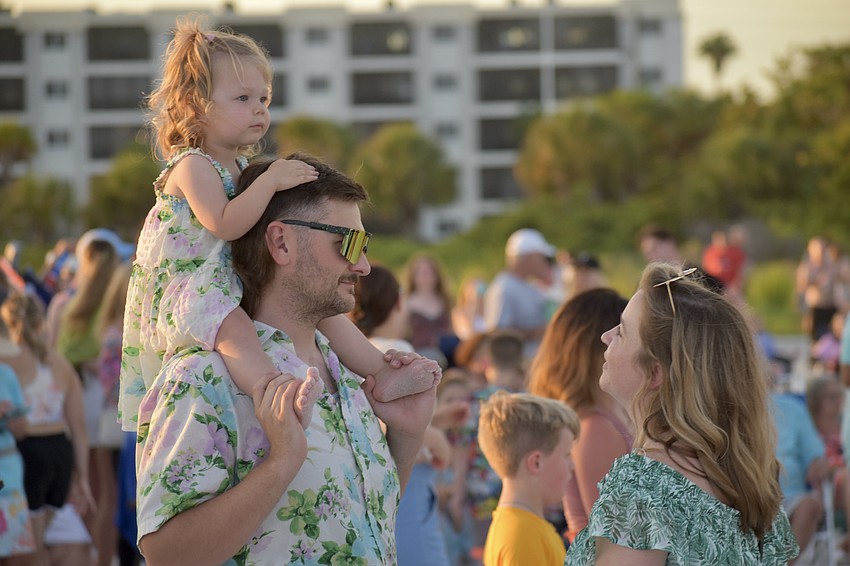 Bonnie Box, 2, watches the drum circle with her parents Taylor and Kyle Box, of Indianapolis