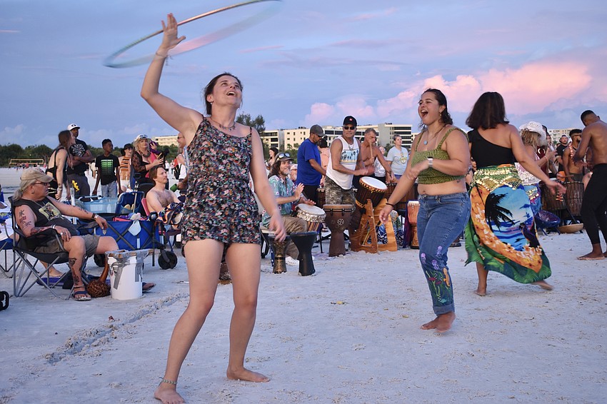 Antonia Tahia shows off her hula hooping skills as Daria Paulis of Boston looks on.