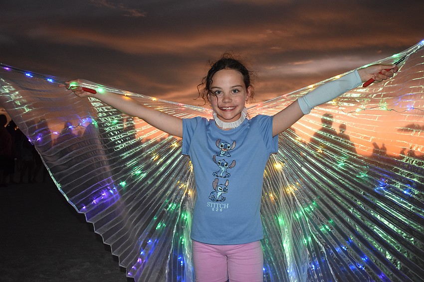 Michisia Croegaert, 10, of Chicago, spreads a pair of wings.