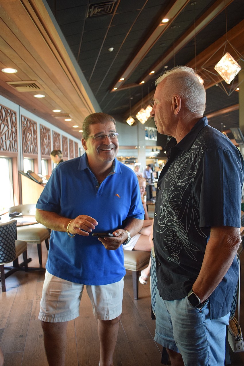 Art Conforti and Leighton Allenby met while walking their dogs. Allenby invited Conforti to the happy hour to continue their mingling.