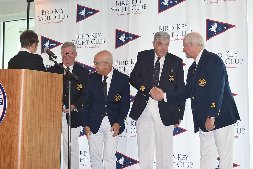 Tony Britt, Saul Landesberg, John Havasy and Colin Wood shaking hands after they were sworn as the new officers.