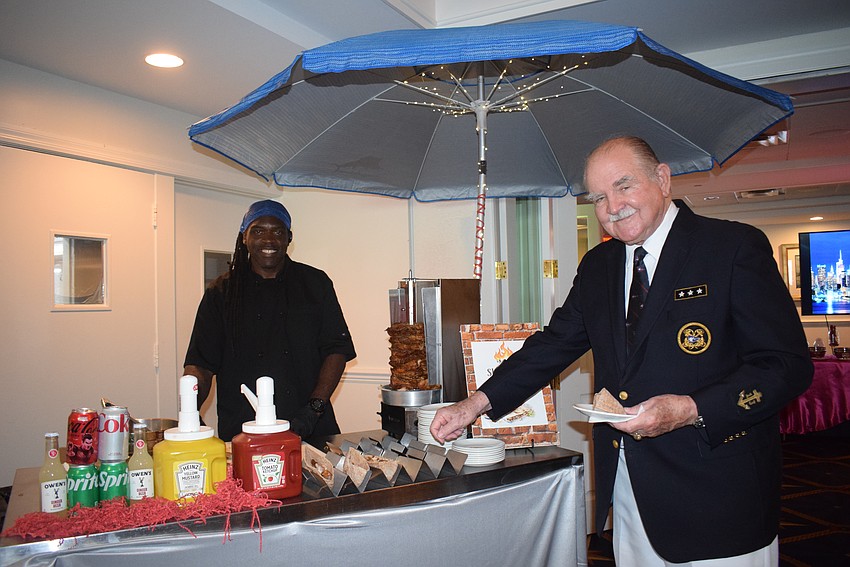 Alonzo Burton serving to shawarma to former Commodore Curt Schantz