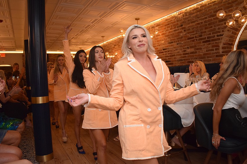 T. Georgiano's models finishing the show in bright orange blazers.