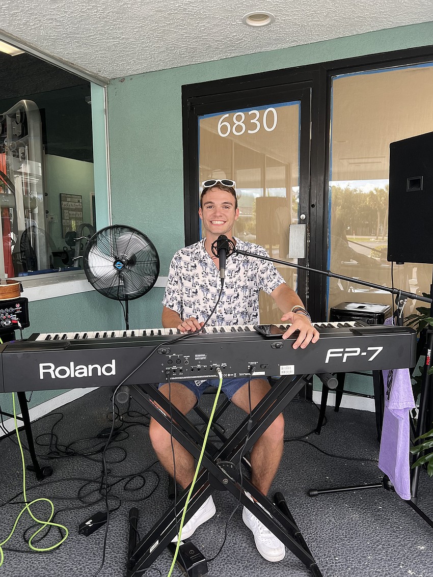 Lorenzo Condensa playing music outside for Whitney Plaza.