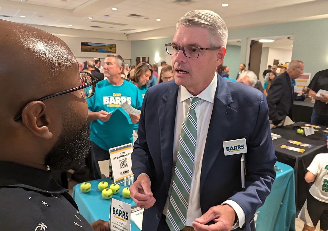 School Board District 3 candidate Derek Barrs speaks to a voter at the Flagler Tiger Bay's Club's Candidate Meet and Greet on June 27. Photo by Brent Woronoff