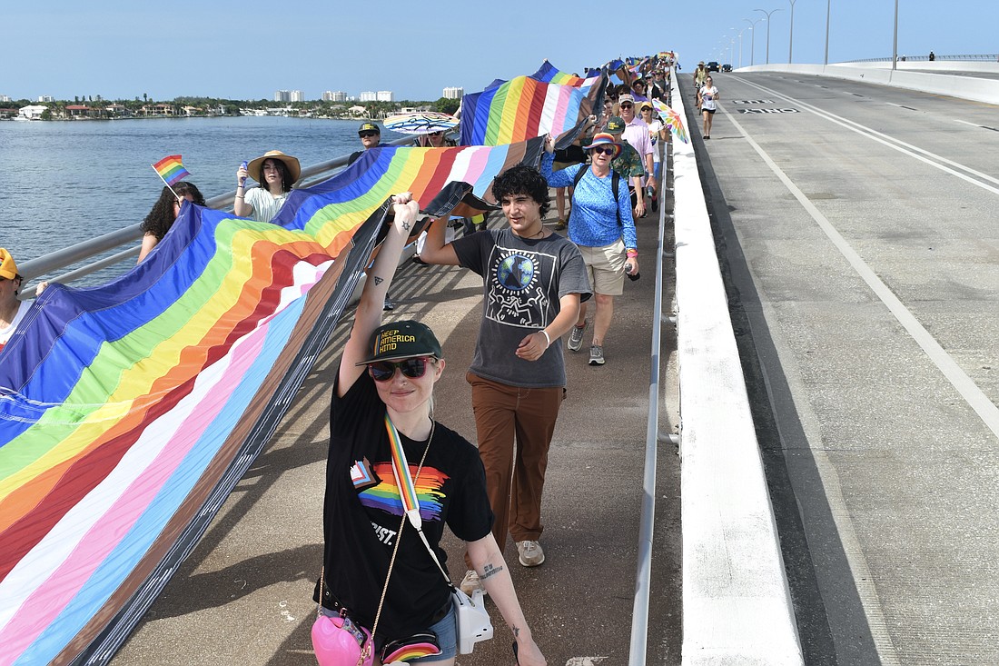 Luna Cassandra and August Ray walk across the bridge.
