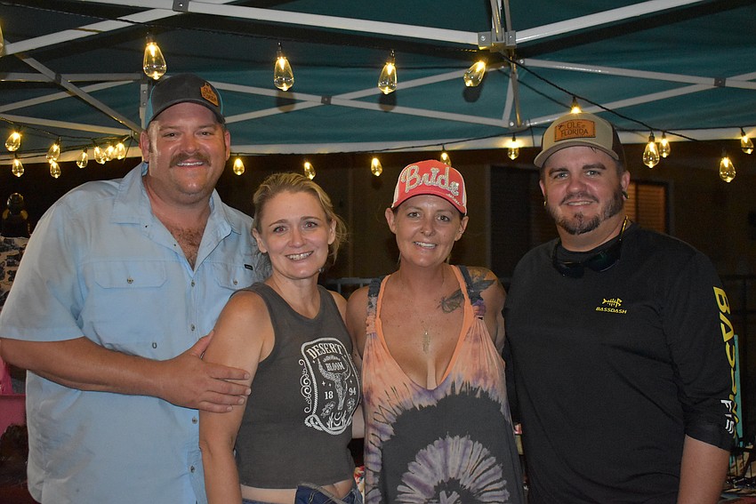 Matt and Becki Johnson are with Courtney Dakin and Sam Harmon under the Rock Your Roots Boutique tent. Becki Johnson owns the western boutique.