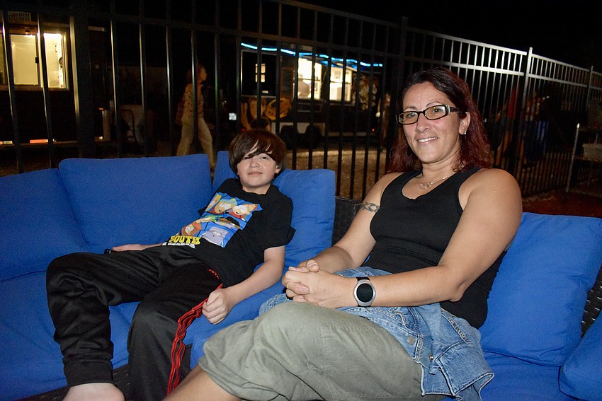 Palmetto residents Kordell Stewart and Annunziata Hernandez get lucky and score some cozy seats to watch the band and fireworks.