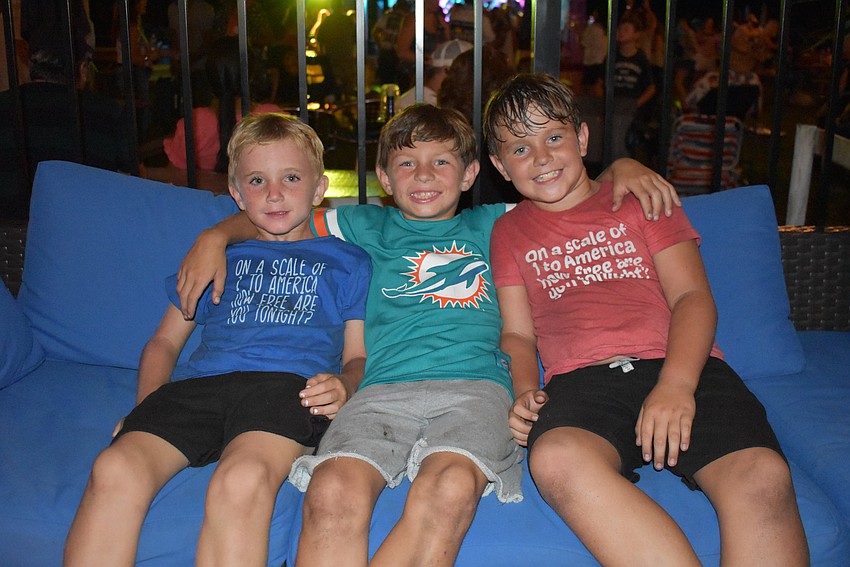 Parrish residents Luca Hudson, 6, Parker Thielking, 9, and Nico Hudson, 9, take a quick break from the playground.