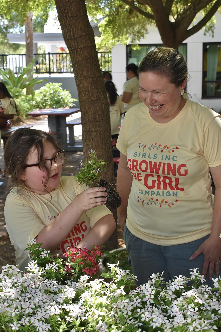 Layla H., 8, and discusses the plants with Delilah Onofrey of Suntory Flowers