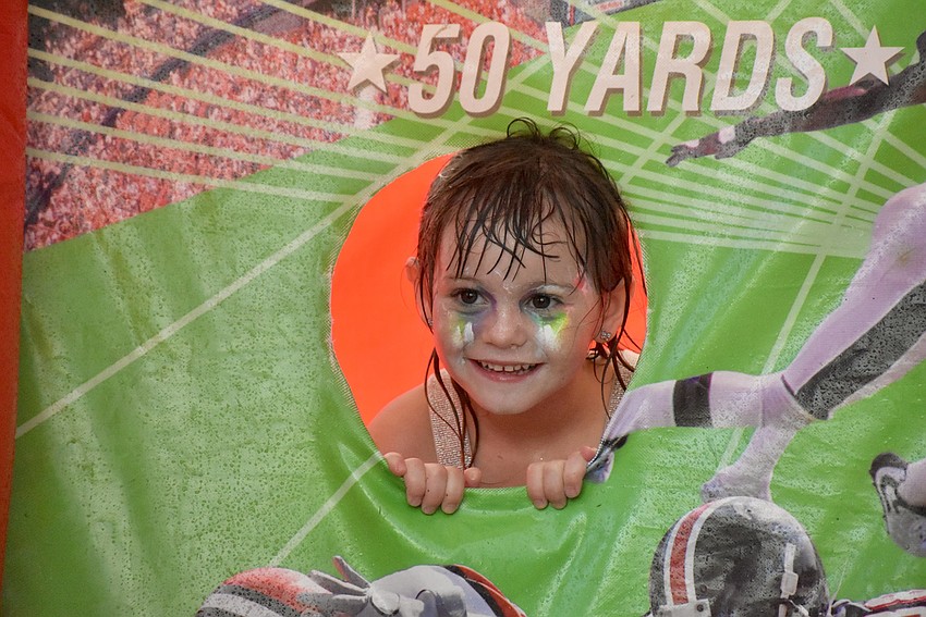 Five-year-old Arianna Moberly's face paint is almost washed off from the rain, but nothing's wiping the smile off her face.