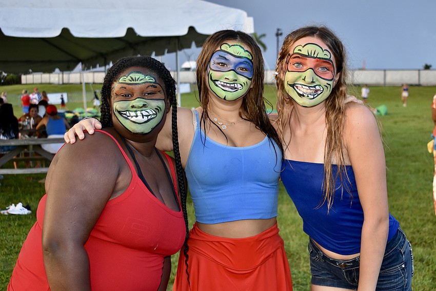 Ari Jordan, Sophia Halley and Keira Nelson have their faces painted like Teenage Mutant Ninja Turtles for the evening.