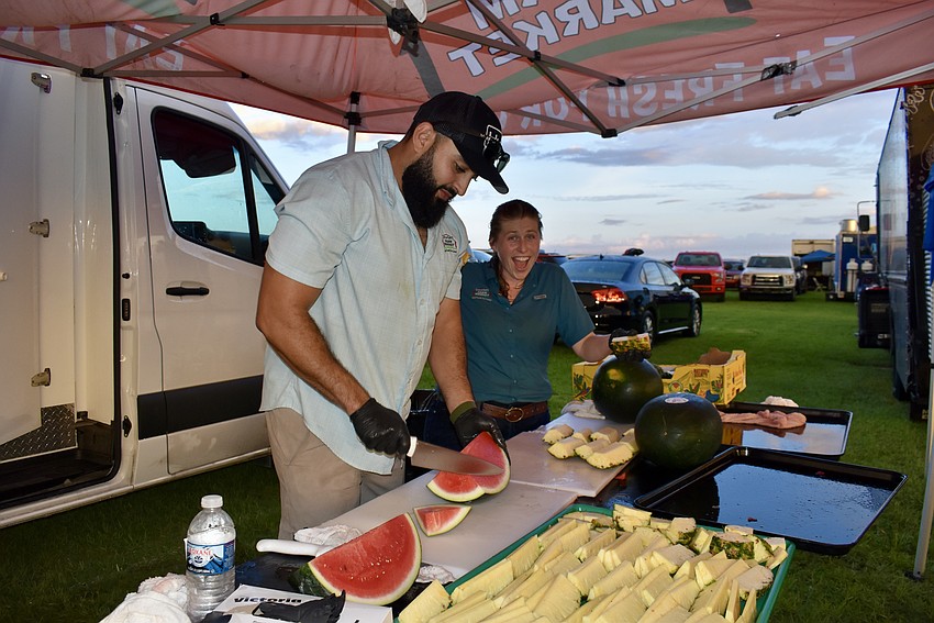 Mohamed Elmennani and Justine Cavender will cut about 100 watermelons and 80 pineapples over the course of the evening. Detwiler's hands out free watermelon every year. The pineapple is a new addition this year.