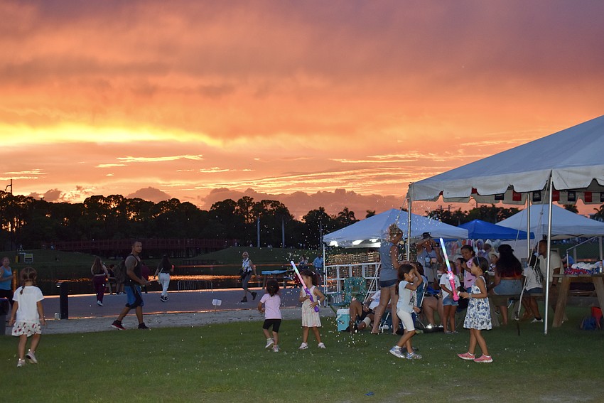 The crowd is treated to a colorful sunset over the lake.