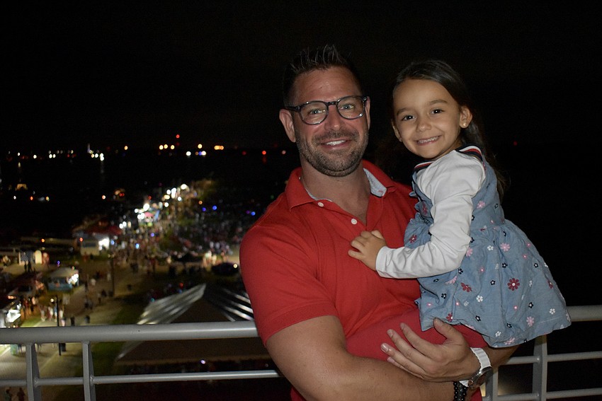 Sarasota resident Jonathan Koltun watches the fireworks with his 4-year-old daughter Lily.
