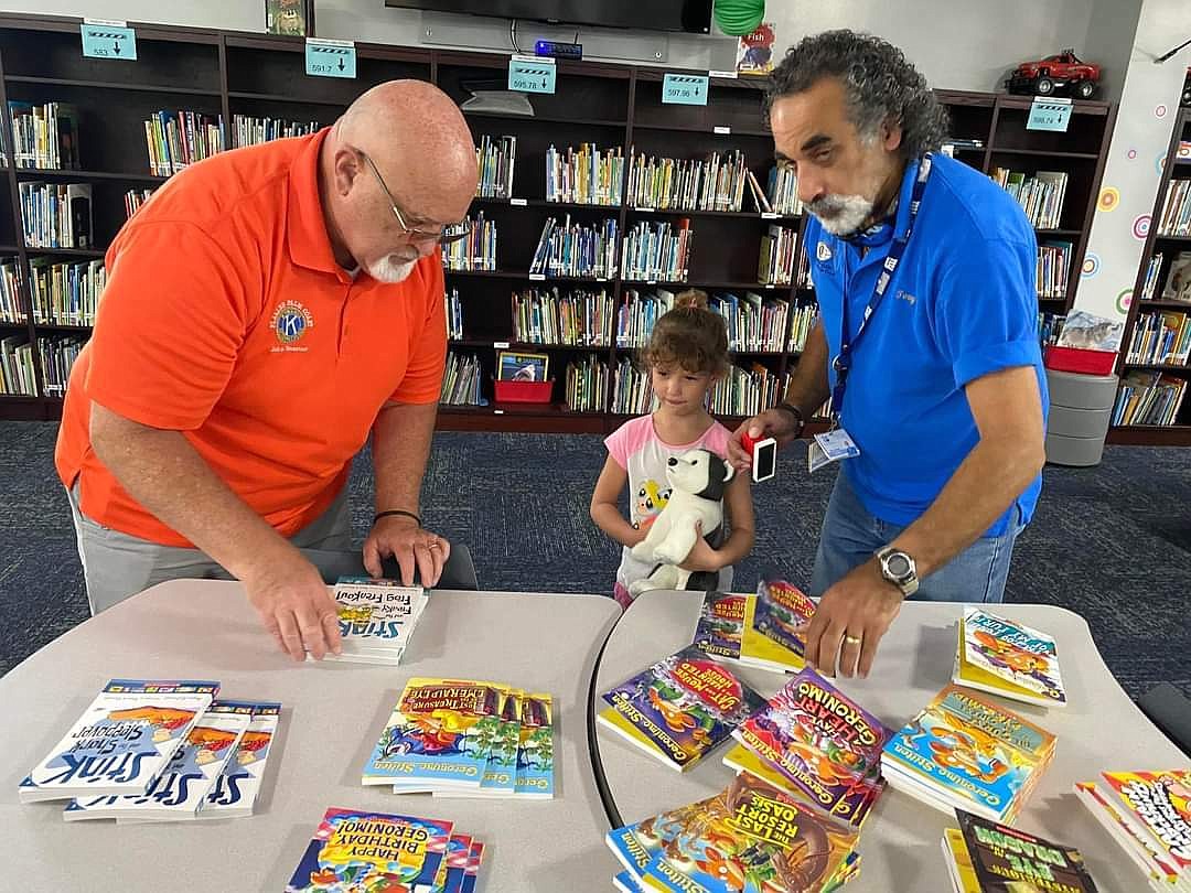 Flagler Palm Coast Kiwanians stamp books to give to students in Bunnell Elementary School's summer reading programs. Courtesy photo