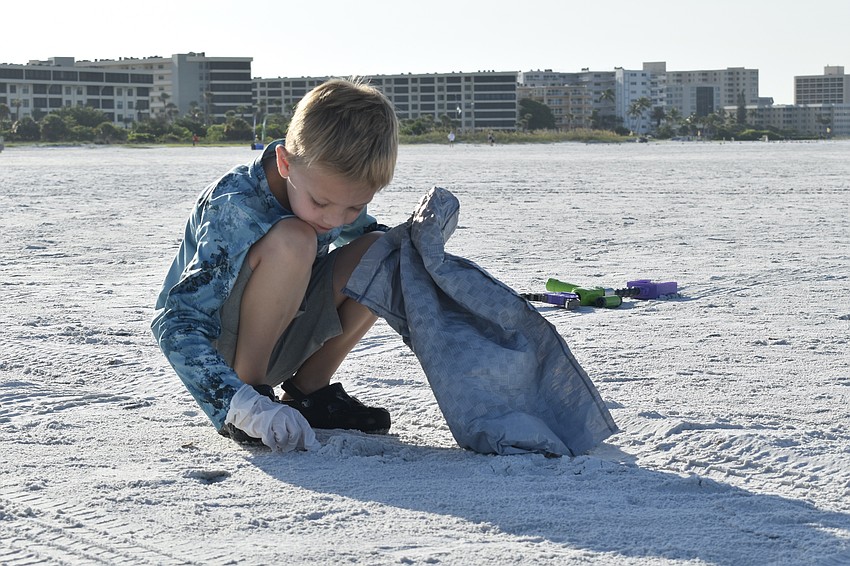 Wyatt Nottingham, 6, finds an object in the sand.