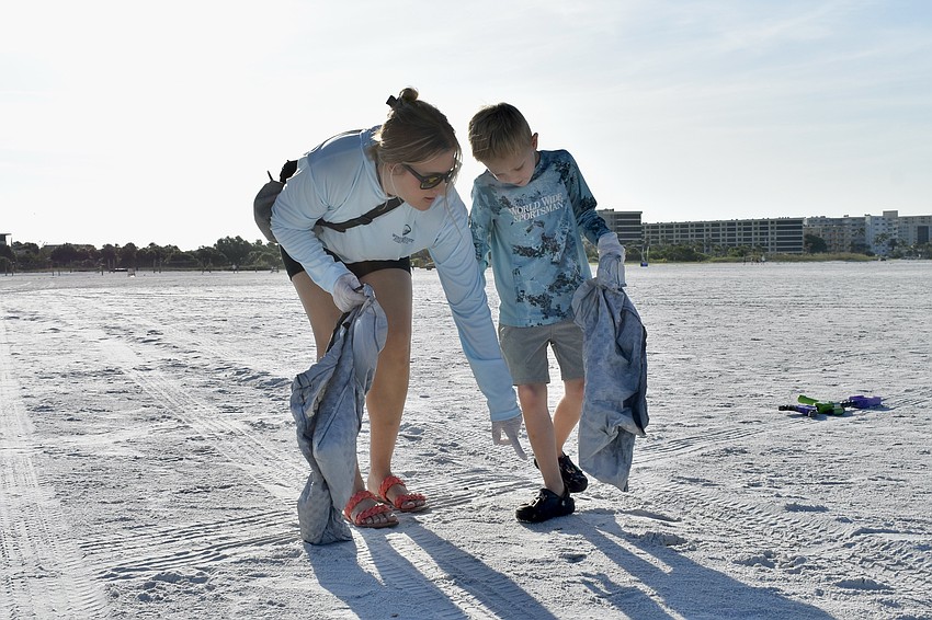 Sarah Nottingham and Wyatt Nottingham, 6, search the beach.