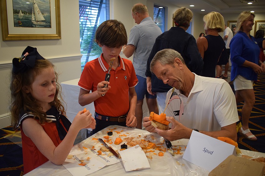 Emma Bailey Gaddy, Walker Gaddy and Curt Nothstine building their potato car.