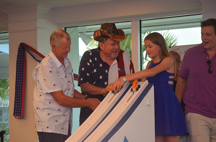 Scott Matthews pulls the lever for the cars to go while JJ Johnson races his potato car.