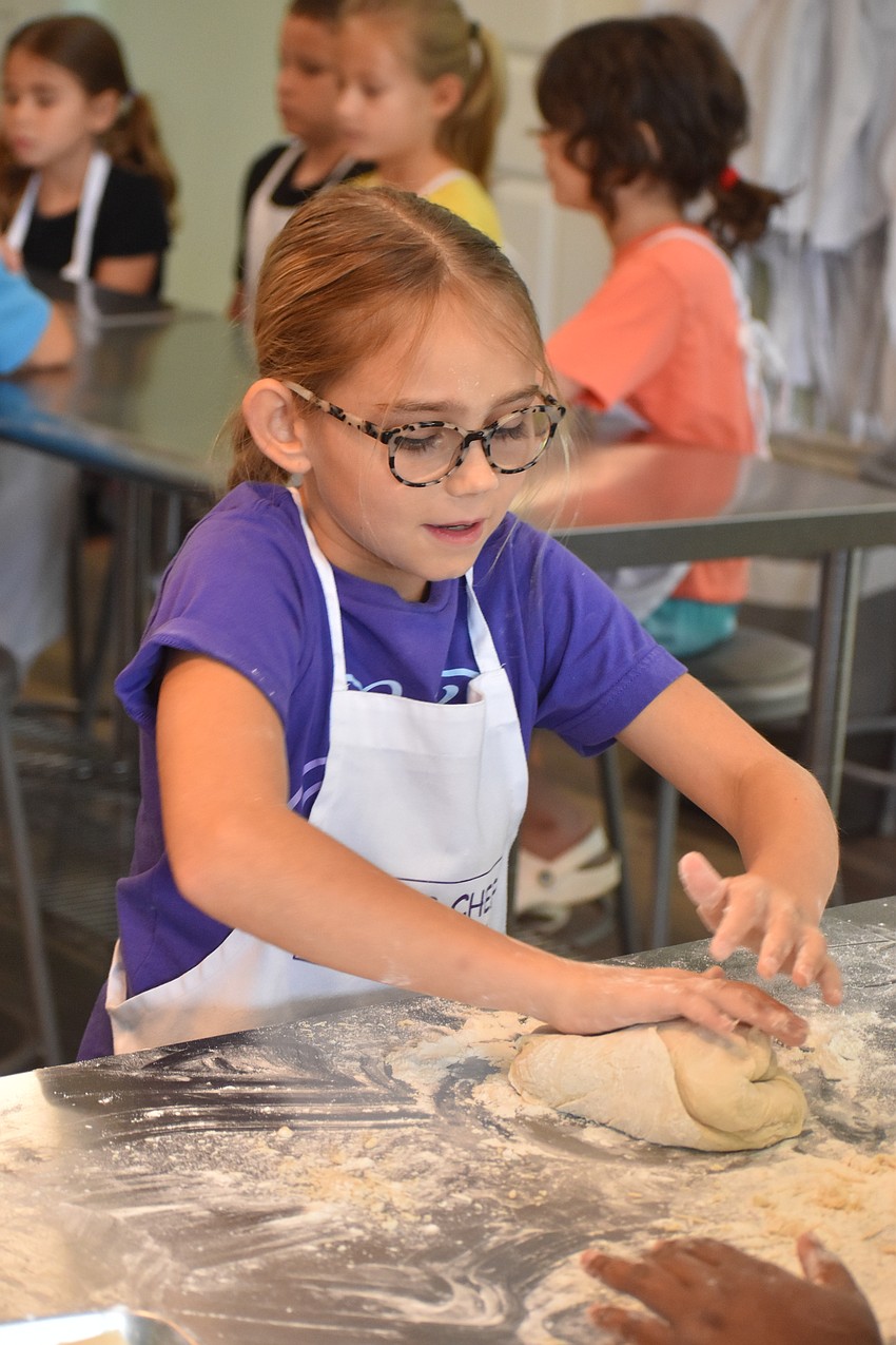 Ellie Rodgers, 9, makes a hot dog bun.