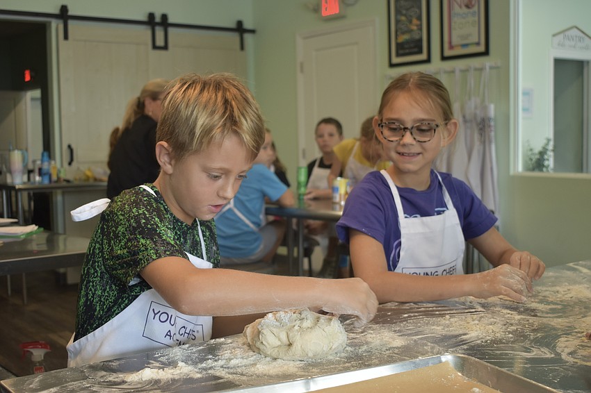 Owen Peacock, 9 and Ellie Rodgers, 9, make hot dog buns.