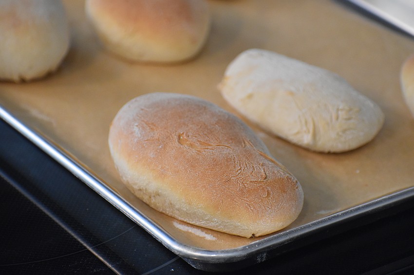 The hot dog buns are finished baking.