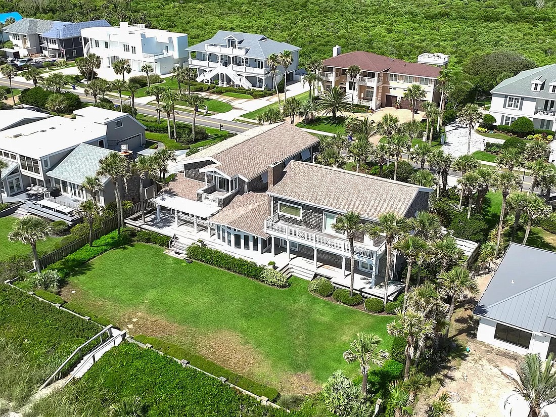 Oceanfront two-story home features five bedrooms, four full and one half-bathrooms, office, porches, balcony, deck, pergola and dune walkover.