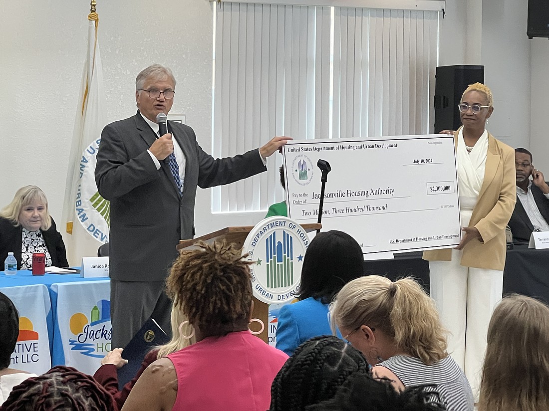 Department of Housing and Urban Development Principal Deputy Assistant Secretary Richard Monocchio presents a ceremonial grant check to Vanessa Dunn, acting CEO of the Jacksonville Housing Authority on July 10.