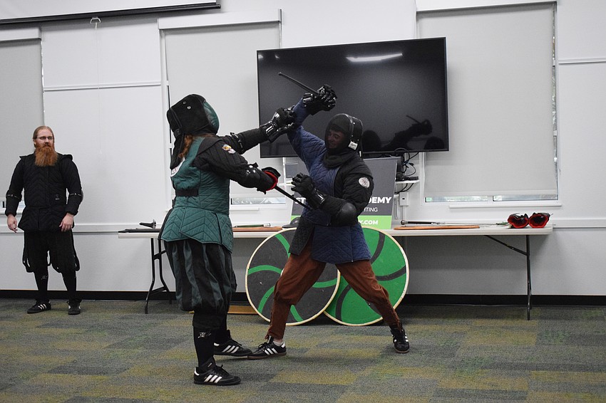 It's close combat between Amanda Closser, the business manager of Steel Ring Academy, and Galloway Gonczy, a teen student, as they fight with daggers.