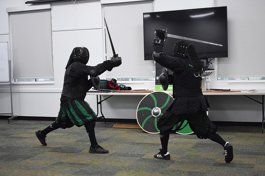 Chris Fontana, a junior instructor with Steel Ring Academy, uses a sword and buckler to fight against Jason Callis, the owner and founder.