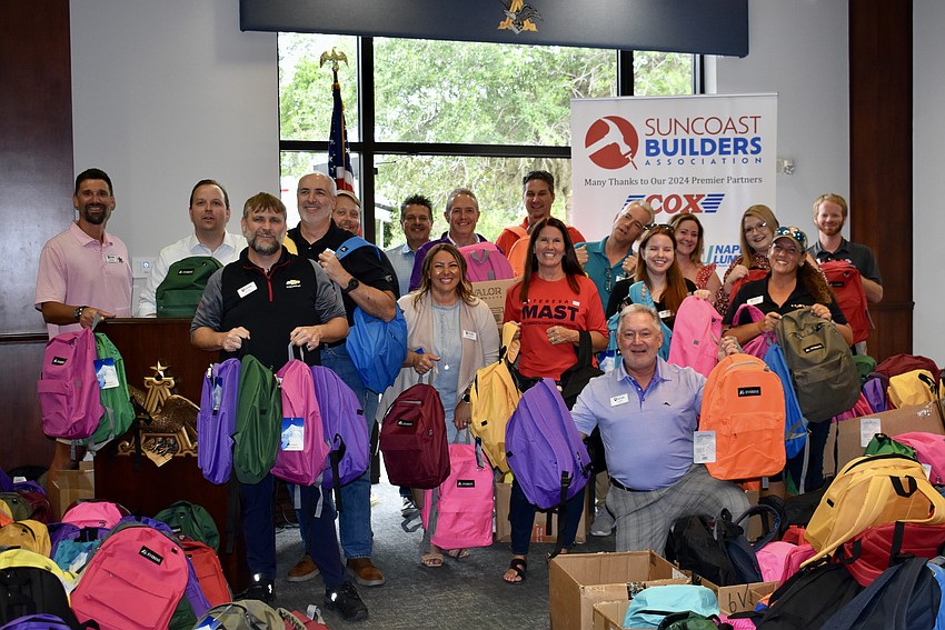 About 20 members of the Suncoast Builders Association stuff backpacks for Boys & Girls Clubs in Sarasota and Manatee counties.