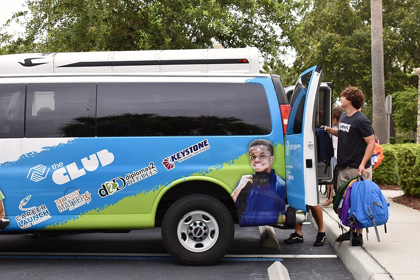 Bradenton resident Jacob Bordner loads more backpacks into Boys and Girls Clubs' van.