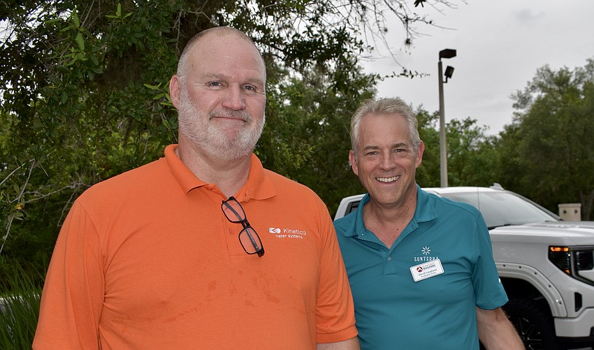 Suncoast Builders Association members Larry Lease and David Langhout volunteer to stuff backpacks on July 11 at Gold Coast Eagle Distributing.