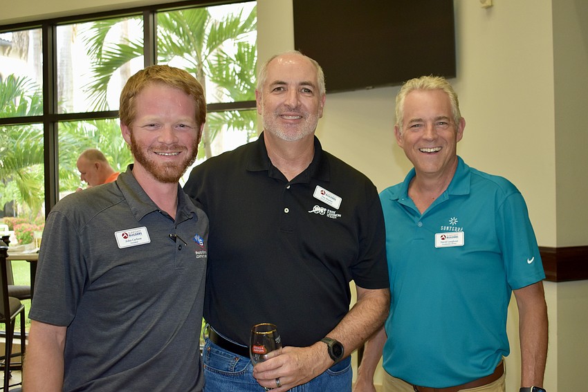 Board President John Carlson chats with board member Tim Martin and Presidential Advisor David Langhout.