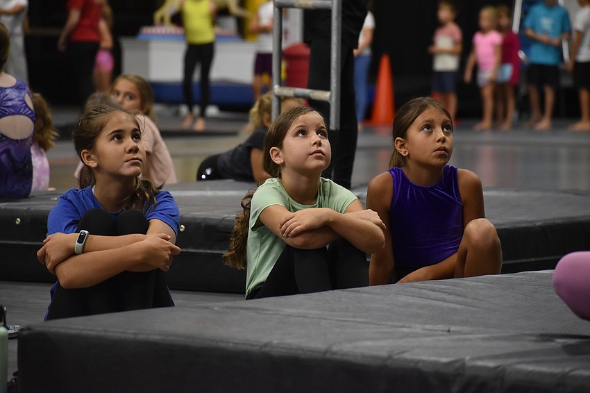 Victoria Faenger, 11, Summer Leicht, 10 and Amelia Swaim, 9, watch a demonstration.