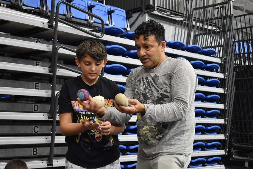Aden Abu-Yousif, 10, learns about juggling from Coach Benito Aguilar.
