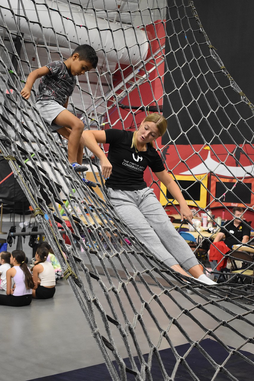 Counselor Hadley Paben and camper Jaden Gadalla, 6, practice climbing.