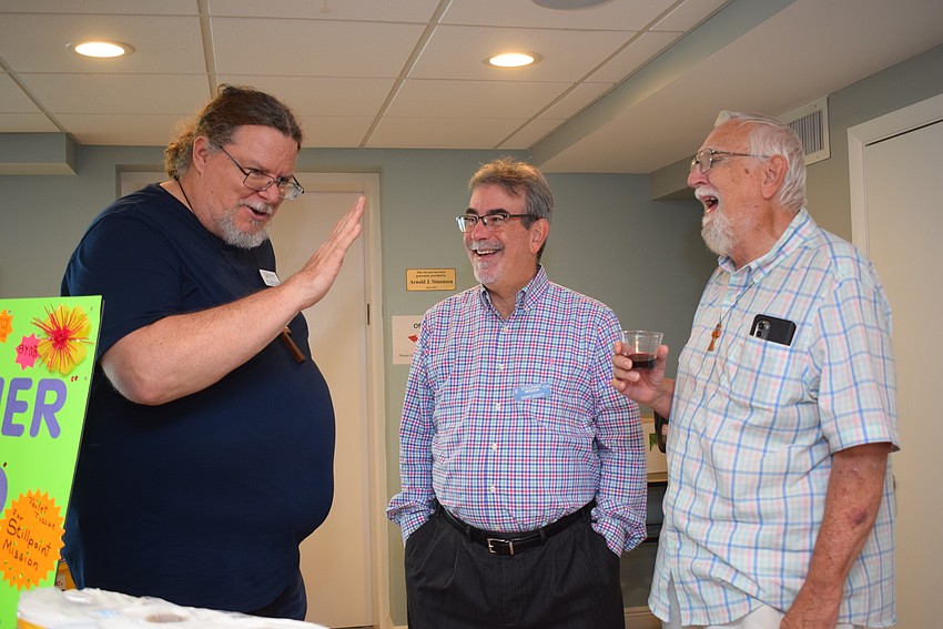 The Rev. Jeffrey Nunes, Gary Scott and Gene Tischer catch up at the Longboat Island Chapel's 