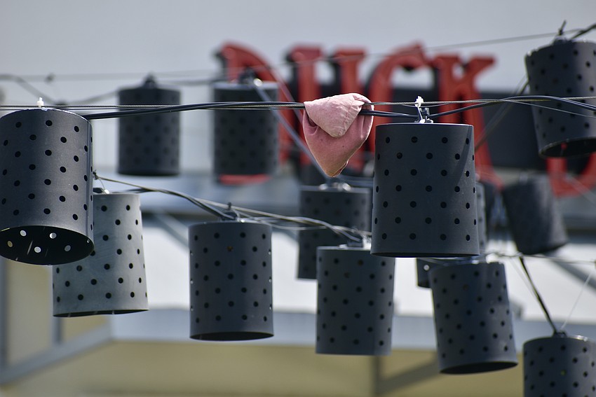 A faded beanbag looks to have been stuck in the string lights for quite a while.