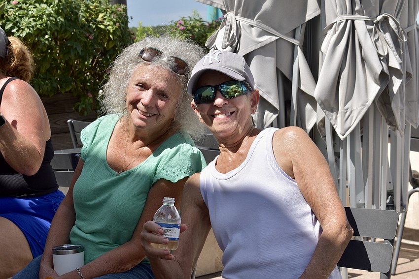 Adriana Gretch and Joann Saladino stay to socialize after cornhole.