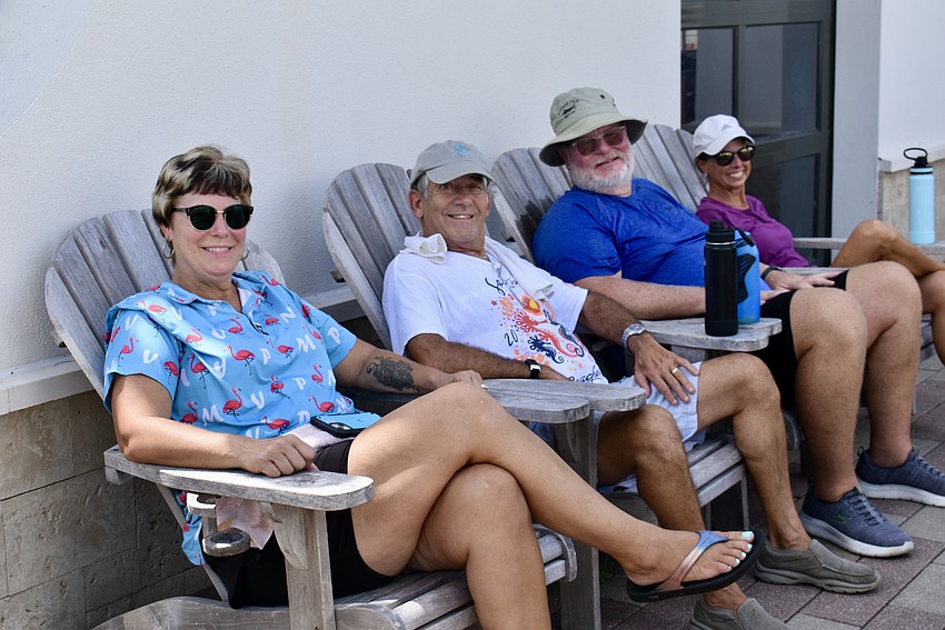 Kelly Harmon, Rich DeStasio, Todd Sears and Linda DeStasio take a seat under the shade after the game.