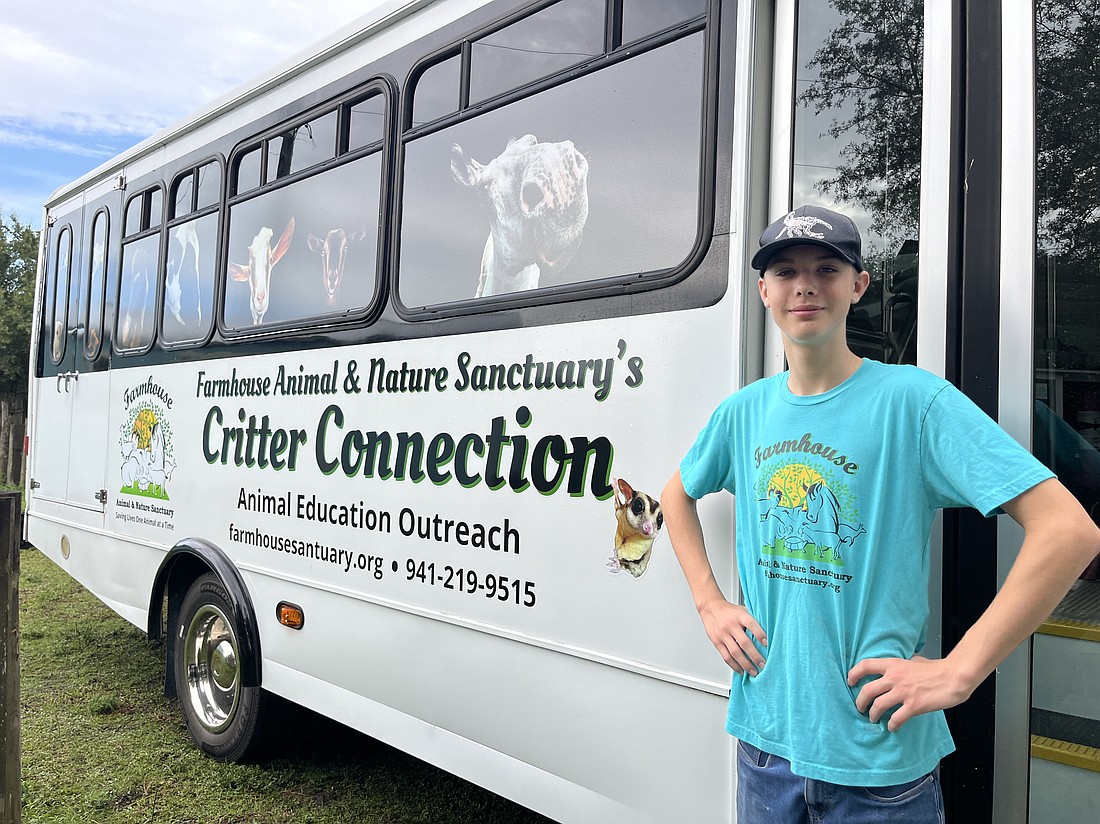 Matthew Burns, a Farmhouse Animal and Nature Sanctuary volunteer, shows off the new shuttle bus that will expand the nonprofit's educational opportunities.