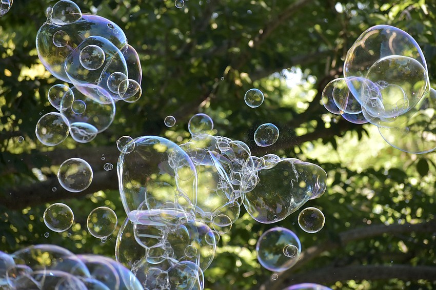 Bubbles drift across the gardens.