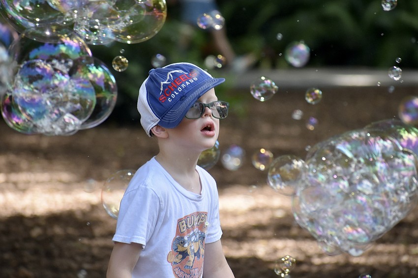Calvin Mortensen, 6, admires the bubbles that fill the air.