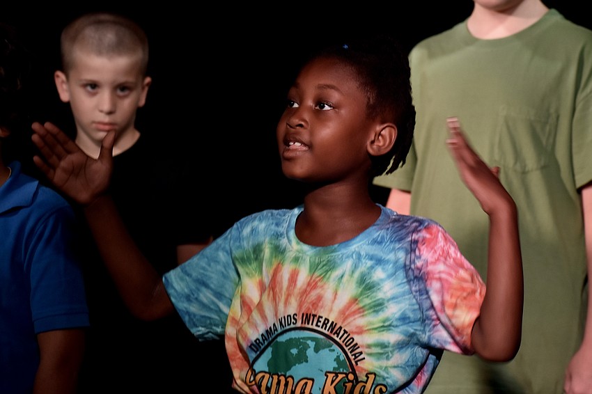 Shanti Tollefson, 7, performs an opening recitation.