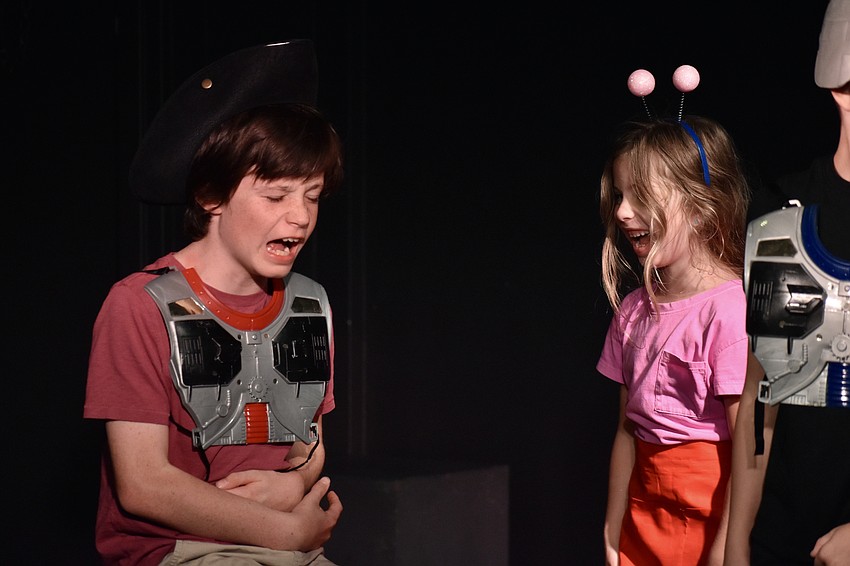 Dominic Guccione, 11, tries some space food from Brooklyn Koenreich, 5.