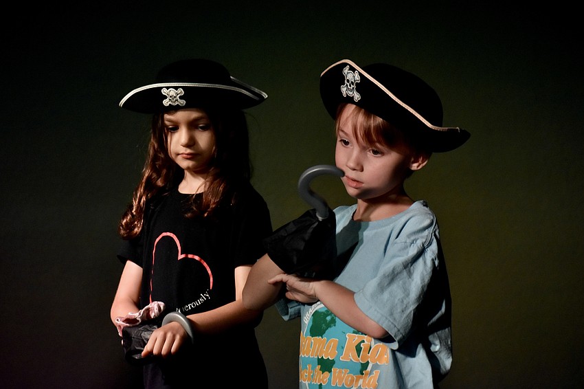 Ember Bly, 5, and Oliver Stillwell, 7, prepare to assume the role of space pirates.
