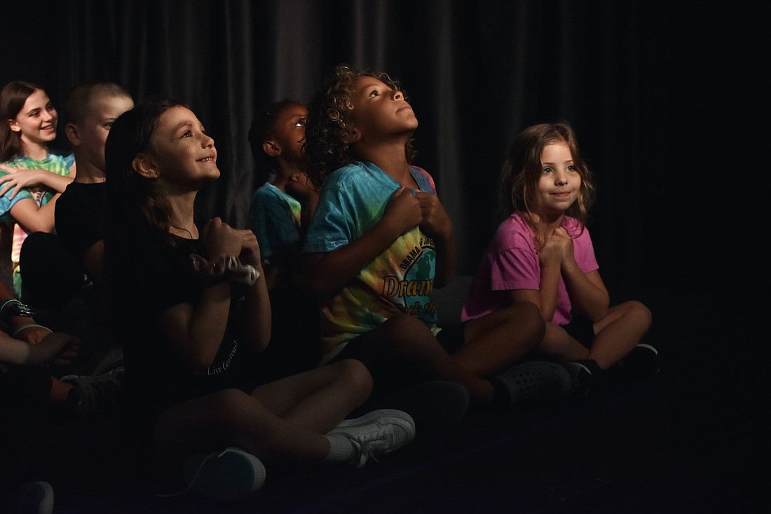 Ember Bly, 5, Avenn Zarchev-Miller, 7, and Brooklyn Koenreich, 5, prepare to blast off into space.